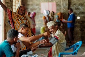 Safari Doctors health worker checking a patient blood pressure.jpg